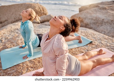 Yoga, relax and woman friends meditating on the beach together for mental health or wellness during summer. Exercise, diversity or nature with a female yogi and friend practicing meditation outside - Powered by Shutterstock