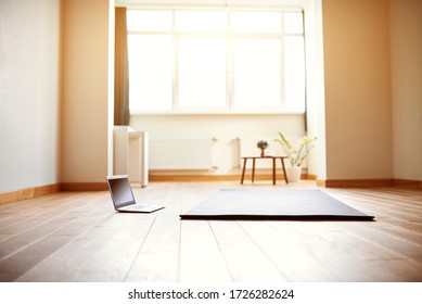 Yoga Room With Big Light Window In Modern Flat. Yoga Mat And Computer On The Floor, No People.