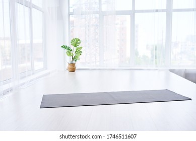 Yoga Room With Big Light Window In Modern Flat. Yoga Mat On The White Floor, No People