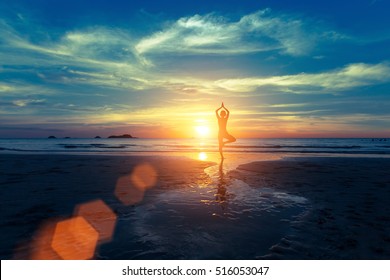 Yoga Silhouette At Sunset On The Sea Shore. Calm And Self-control.