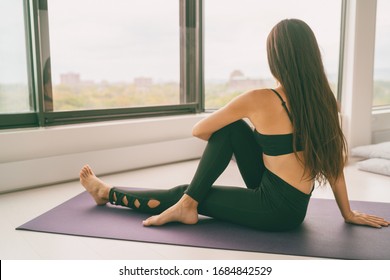 Yoga stretch exercise at home fit happy woman stretching lower back for spine health relaxing at home. Floor easy workout for home.