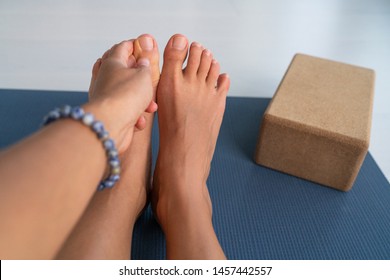 Yoga Stretches Big Toe Pull Stretch Exercises Woman Doing Hamstring Stretching At Home On Fitness Mat Training Stretching Legs Touching Toes. Hand Wearing Mala Bracelet With Yoga Block.