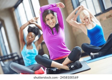 Yoga, stretching and women in gym for wellness, fitness and exercise with diversity in health facility. Girl, people and coach with athlete class training for energy, balance and workout with team - Powered by Shutterstock