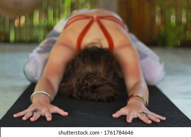 Yoga Student Relaxing In Child’s Pose During A Health Retreat In Bali