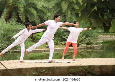 Yoga Teacher Practicing Yoga With His Students In A City Park In A Peaceful Environment