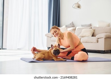 Yoga Time. Woman With Pug Dog Is At Home At Daytime.