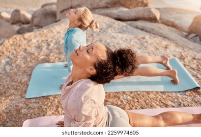 Yoga, wellness and woman friends on the beach together for mental health or balance in summer from above. Exercise, diversity or nature with a female yogi and friend practicing meditation outside - Powered by Shutterstock