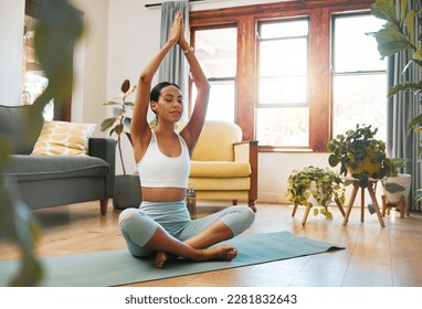 Yoga, woman and hands above head for meditation, training and exercise at home living room, wellness and holistic health. Calm biracial person meditate, prayer or praying position in pilates workout - Powered by Shutterstock