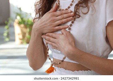 Yoga Woman Meditating, holding hands on the heart close up. Loving Kindness Meditation, Self-love , Gratitude concept