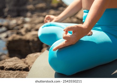 Yoga woman meditation lotus pose with hand mudra gyan gyana jnama at cliff sea beach closeup. Yogi female meditating relax balance harmony mindfulness posture spiritual practice outdoor training - Powered by Shutterstock