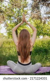 Yoga Woman On Green Grass Girl Relaxes In The Field. Yoga Woman In Green Park Girl Doing Gymnastics Outdoors. Meditating Woman In Meditation In Yoga Pose Practices Outdoors.