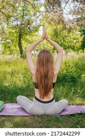 Yoga Woman On Green Grass Girl Relaxes In The Field. Yoga Woman In Green Park Girl Doing Gymnastics Outdoors. Meditating Woman In Meditation In Yoga Pose Practices Outdoors