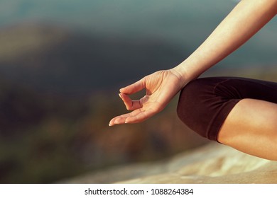 Yoga woman. Yoga poses. Cropped close up of female in lotus position meditating in the mountains happiness living vitality health balance recreation relaxation freedom nature body care concept