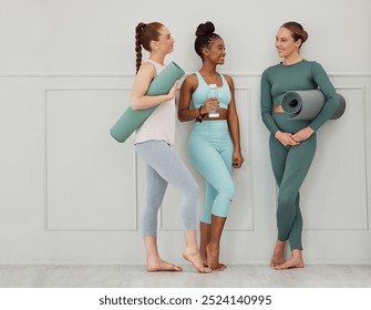 Yoga, women and conversation with gym mat at wellness, health and pilates studio with friends. Happy, smile and chat with training and fitness fashion with bottle and exercise gear with diversity - Powered by Shutterstock