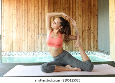 Yogi Woman Doing Yoga Advanced Pose In Spa Pool