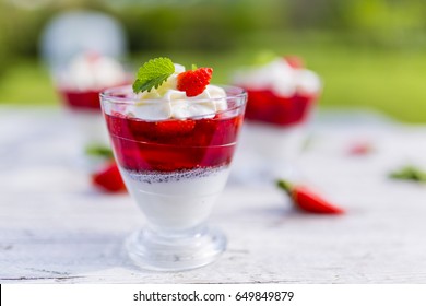 Yogurt with chia seeds and jelly and fresh strawberries. 