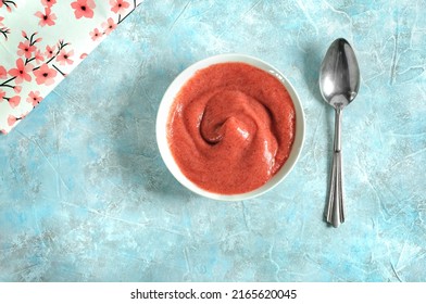 Yogurt, cream, mousse or smoothie in a white ceramic plate with a spoon on a blue marble background. Daylight, selective focus. View from above - Shutterstock ID 2165620045
