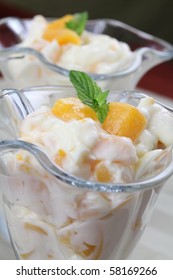 Yogurt dessert with peaches and mint