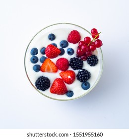 Yogurt With Fresh Berries In A Bowl Isolated On White Background