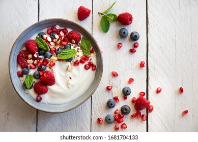 Yogurt With Fresh Fruit And Berries (raspberry, Pomegranate, Blueberry) And Mint For Healthy Breakfast