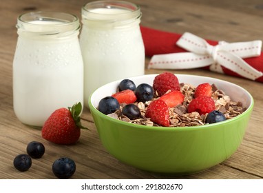 yogurt with fruit and musli on wooden background