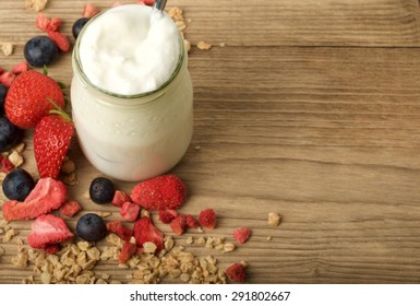 yogurt with fruit on wooden background
