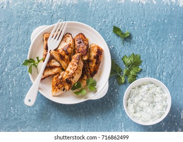 Yogurt Marinated Grilled Chicken Breast On A Blue Background, Top View