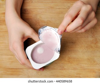 Yogurt with mold in female hands