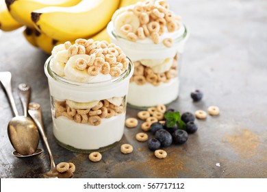 Yogurt parfait with cereal, banana and maple syrup