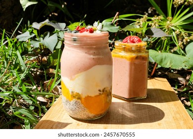 Yogurt parfait + Strawberry smoothie Jar topped with freah strawberry, bluberry, apple flower and nuts and seeds, healthy summer fresh and refreshing breakfast bowl  - Powered by Shutterstock