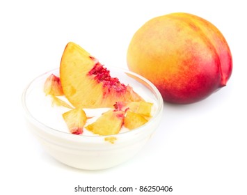Yogurt with peach segments on a white background
