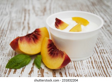 Yogurt with peaches on a wooden background