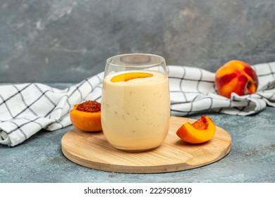 Yogurt with peaches. Summer breakfast drink, fresh blended peach smoothie, place for text. - Powered by Shutterstock