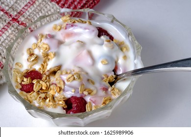 Yogurt Raspberry Parfait In A Bowl With Spoon. Shot From Above With White Background