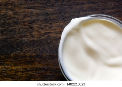 Yogurt Or Sour Cream Bowl On Wood Background