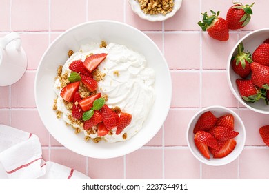 Yogurt with strawberry. Plain white greek yogurt with fresh berries and granola. Healthy food, breakfast. Top view - Powered by Shutterstock