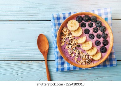 yogurt or yoghurt smoothie bowl with blue berry, banana and granola - Healthy food style - Powered by Shutterstock