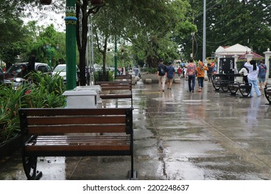 Yogya, ID - Sept 10th, 2022. Empty Wooden Bench From The Back At The Side Walk Pedestrian Malioboro Street At The Afternoon After The Rain Falls. Romantic View At The Middle Of Yogyakarta City.