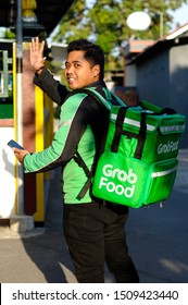 Yogyakarta, 18 September 2019 : A Grab Food Driver Is Ready With His Full Attributes, Namely Jackets And Grab Food Bag.