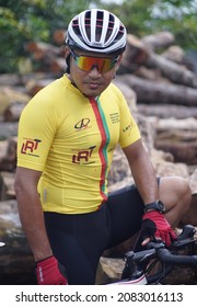 Yogyakarta 30 November 2021 A Man With Glasses With Stylish Cycling Gear On A Pile Of Wood