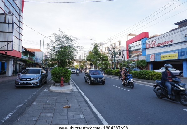 YOGYAKARTA CITY, INDONESIA - 25 December 2020; The\
landscape of Margo Utomo road towards Malioboro street in the city\
of jogja during the afternoon is busy with passing vehicles.\
Selective focus