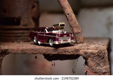 Yogyakarta, ID. September 7, 2022. Purple Johnny Lightning Chevy Nomad Hot Rod Diecast Car On Rusty Background