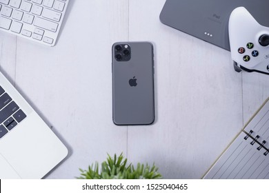 Yogyakarta, IDN - Oct 6, 2019 : Top View Of Apple Products Tech Mockup Includes Macbook, Ipad , Game Controller, And New IPhone 11 Pro Space Grey