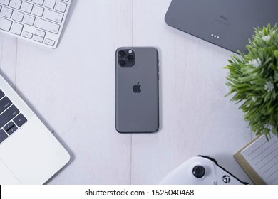 Yogyakarta, IDN - Oct 6, 2019 : Top View Of Apple Products Tech Mockup Includes Macbook, Ipad , Game Controller, And New IPhone 11 Pro Space Grey