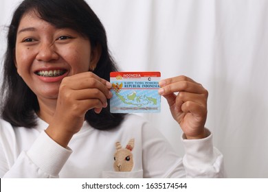 Yogyakarta, Indonesia - 01/24/2020 : A Girl Hold Indonesian Identity Card And Drive License