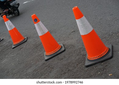 Yogyakarta, Indonesia- 05 April 2021; A Traffic Cone On The Roadside Of Malioboro, Yogyakarta With Electronic Arrows Pointing The Road On To Divert Traffic.