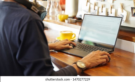 Yogyakarta, Indonesia - 30 July, 2019: Young Hispter Fashion Man Working On Laptop In Coffe Shop