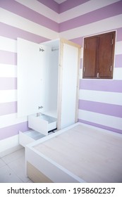 Yogyakarta, Indonesia - April 19 2021: Minimalist wooden wardrobe in a purple bedroom from several angle.