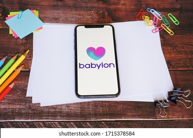 Yogyakarta, Indonesia - April 27, 2020; Babylon Iphone Screen With Stationery On A White Papers. Babylon Health Is A Health Service Provider. #Babylon Health