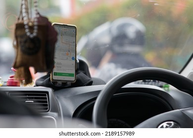 Yogyakarta, Indonesia - August 10, 2022: Online Taxi Driver Or Gojek Grab Car Driver Is Driving The Passenger To The Destination.